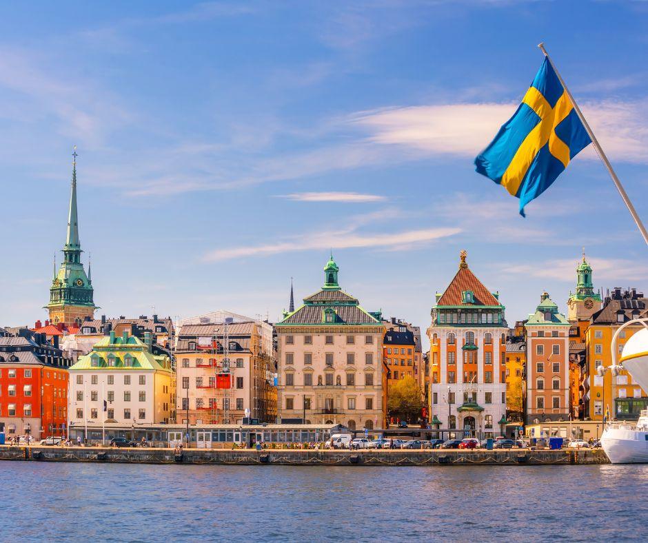 View of stockholm from the sea. In the picture we may see several buildings and a Swedish flag on the side